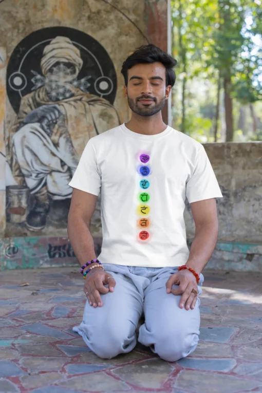 man wearing 7 chakra yoga tshirt and meditating