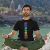 man wearing 7 chakra yoga black tshirt and meditating