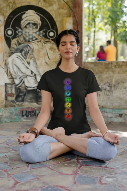 girl wearing 7 chakra yoga black tshirt and meditating