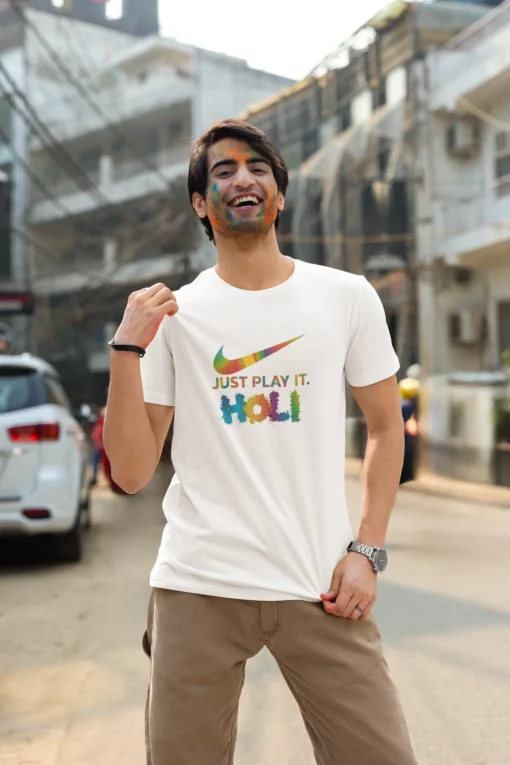 man wearing just play it holi tshirt